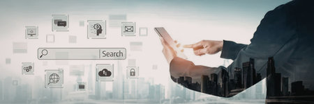 A person in a business suit is shown from the chest down, holding a mobile device in their left...