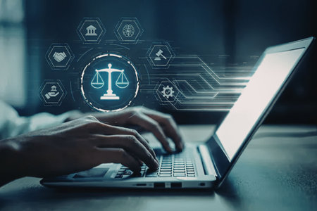 A person working on a laptop with legal icons floating above the keyboard, including a scale of...