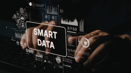 Person interacts with smart data visualization on a laptop screen, analyzing business information in...