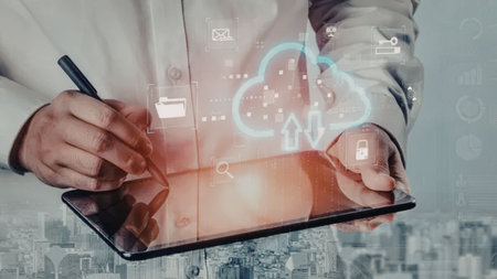 Business professional interacts with digital cloud storage interface on a tablet device, symbolizing...