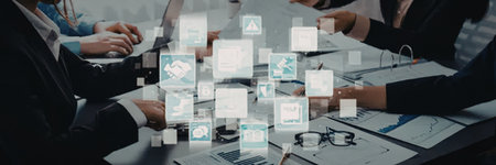 Business professionals engage in a strategic meeting, analyzing financial data and interactive...