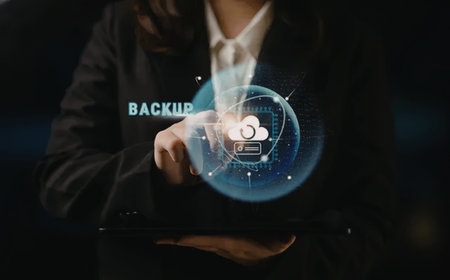 Businesswoman engages with virtual backup interface on tablet showing cloud data storage security...