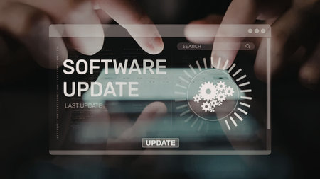 Person updates software on a touchscreen device displaying a progress indicator with gears,...