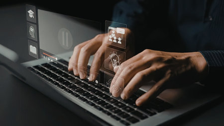 Person's hands typing on a laptop with a virtual interface showing various learning concepts and...
