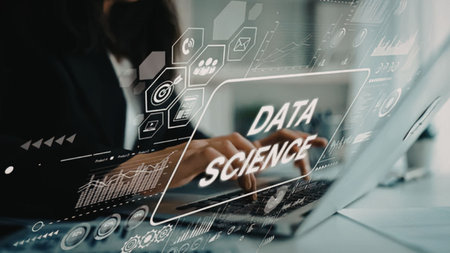 Data scientist working on laptop with data analysis and visualization tools on screen in a...