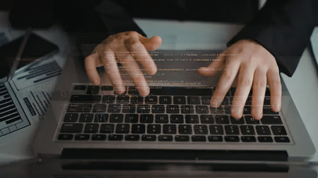 Professional's hands rapidly type on a laptop keyboard, executing intricate code or data processing,...