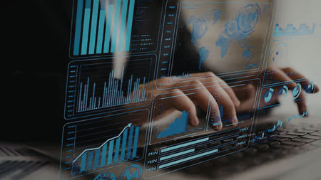 Professional analyzing business data on a laptop displaying futuristic statistics and global market...