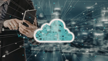 a person holding a tablet with a large cloud icon in front of them. the cloud is made up of small...