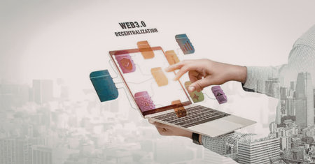 A futuristic illustration of a hand holding a laptop with colorful squares floating above the...