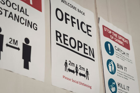 A collection of office reopening posters emphasizing social distancing and health measures.