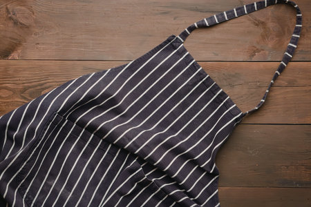 A stylish black and white striped bag placed on a wooden surface.
