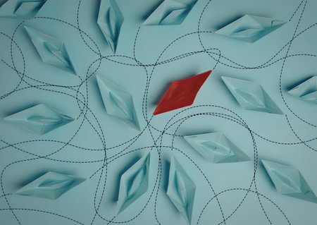 A close-up of an abstract paper snowflake with a red diamond in the center, on a blue background.