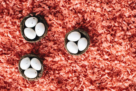 Easter white eggs in three small baskets