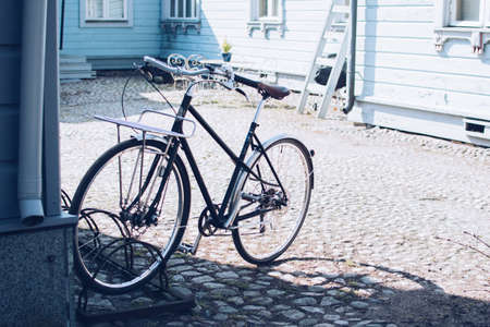 City bike on the background of blue wooden house.の写真素材