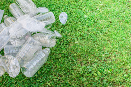 Pile of used plastic bottles on the grass, the concept of ecology. Waste separation concept.の写真素材