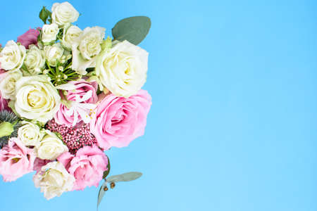 Colorful beautiful bouquet of different fresh flowers on the  light blue background. Floral arrangement. Top view.の写真素材