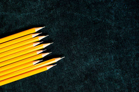 Lots of pencils on black board background with copy space. Back to school concept. Flat lay.の写真素材
