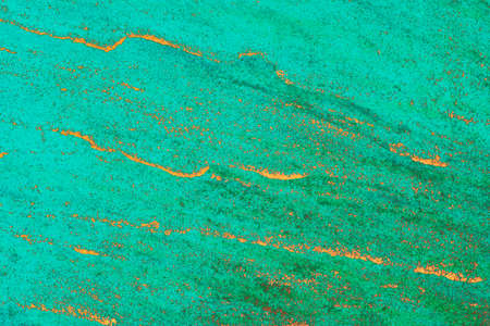 Bright green texture for designer background. Abstract background of cracked plaster. Great for...