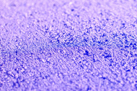 Texture of sparkling first cold ice. Snowy backdrop in purple colors. Winter background for design. Abstraction in nature.の写真素材