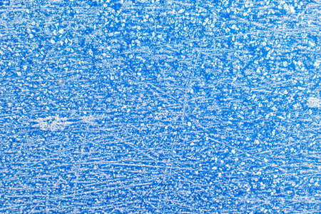 Texture of sparkling first cold ice. Blue snowy backdrop. Winter background for design. Abstraction...