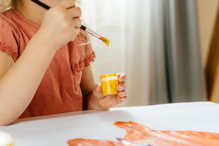 The girl spending a time drawing the picture using laptop at home. Distance learning, online education.の写真素材