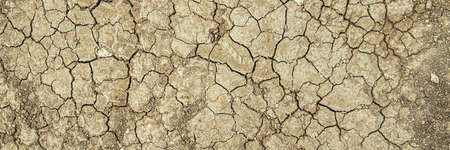 Brown dry cracked ground. Dried clay texture and patterns cracked surface of clay and land. Banner.の写真素材