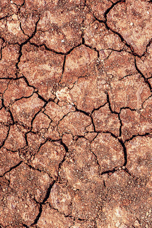 Red dry cracked ground. Dried clay texture and patterns cracked surface of clay and land.の写真素材