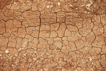 Red dry cracked ground. Dried clay texture and patterns cracked surface of clay and land.の写真素材