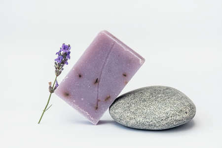 Lavender soap on the pedestal from sea stone on light background.の写真素材