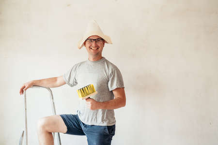 Plasterer home improvement handyman worker makes repairs. Renovation diy new home painting wall.の写真素材