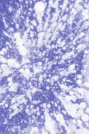 Abstract background of air bubbles in the frozen lake. Trendy color of 2022.