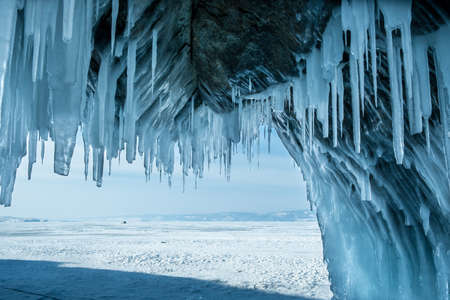 Inside the ice cave with icicles on the Lake Baikal in winter. Siberia, Russia.の写真素材
