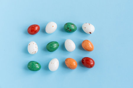 Easter minimal composition with multicolored eggs on the blue background. Easter concept. Flat lay.の写真素材