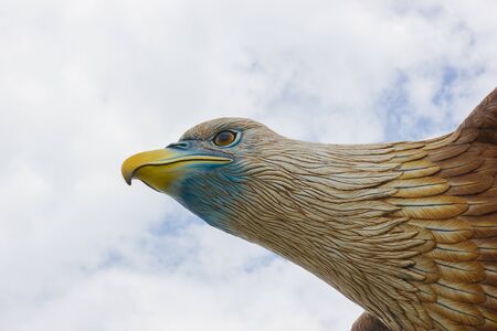 Head of big eagle statue on the sky background
