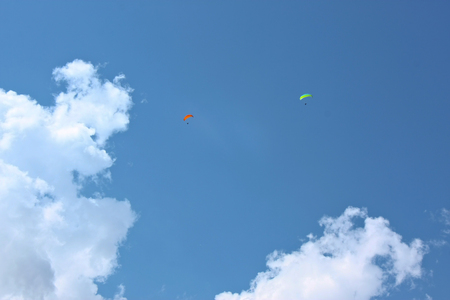 two Paragliders flying hihg in the clouds in Italyの写真素材