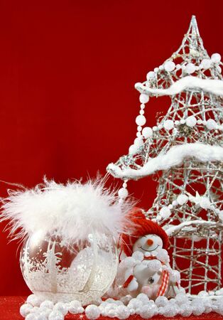 white Christmas tree and decorations with toy snowman at the red backgroundの写真素材