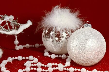 Christmas new year decorations toy , white fluffy crystal bubbles, white beads at the red backgroundの写真素材