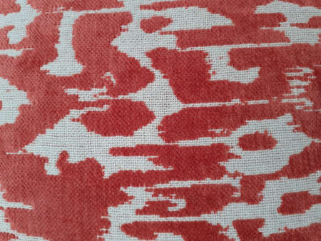 Background from a textile material red and white. Fabric with natural texture.