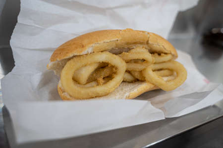 A squid sandwich on the metal bar of a barの写真素材