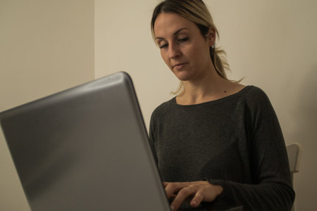 close-up of woman writing on the computerの写真素材