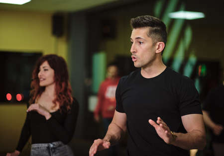 A young woman and a man teaching Salsa and Bachataの写真素材