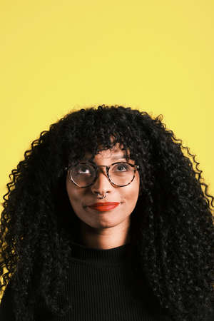 young african american woman looking up and having an ideaの写真素材