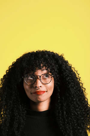 young african american woman looking up and having an idea