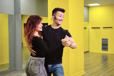 A young woman and a man teaching Salsa and Bachataの写真素材