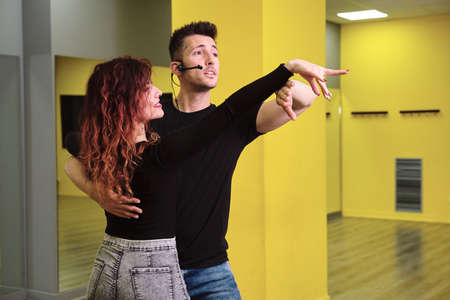 A young woman and a man teaching Salsa and Bachataの写真素材