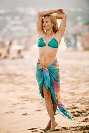 a young skinny blonde model at the beach at sunset - weight loss conceptの写真素材