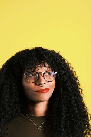 young african american woman looking up and having an ideaの写真素材