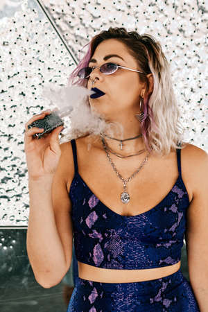 young alternative girl using vaporizer - lifestyle conceptの写真素材