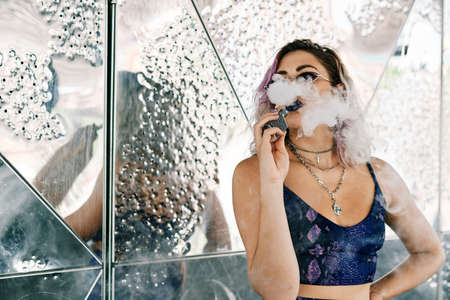 young alternative girl using vaporizer - lifestyle conceptの写真素材