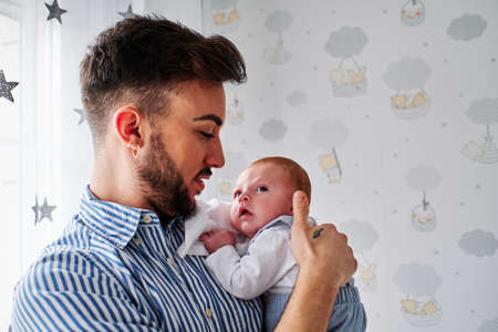 a young father taking care of a newborn